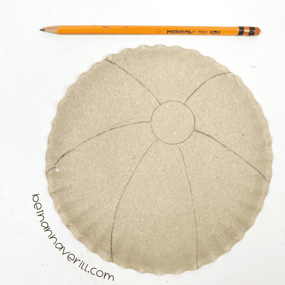 Paper plate divided into six sections with pencil lines