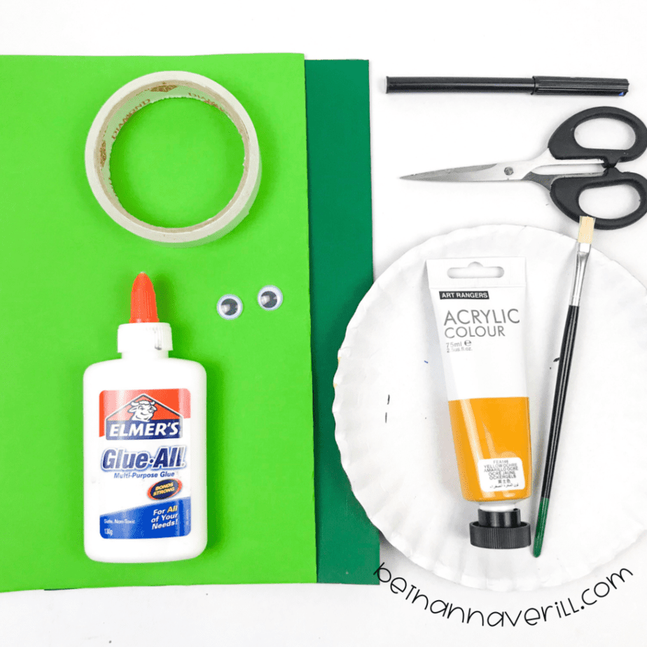 Paper plate, green paper, yellow paint, googly eyes, tape and scissors