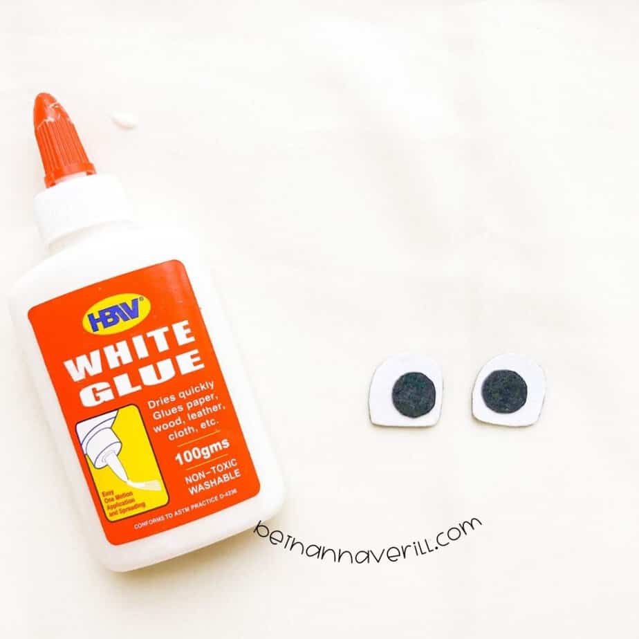 Small black circles glued onto white eyes