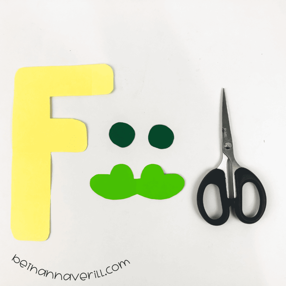 Green frog face glued to the top of the yellow F