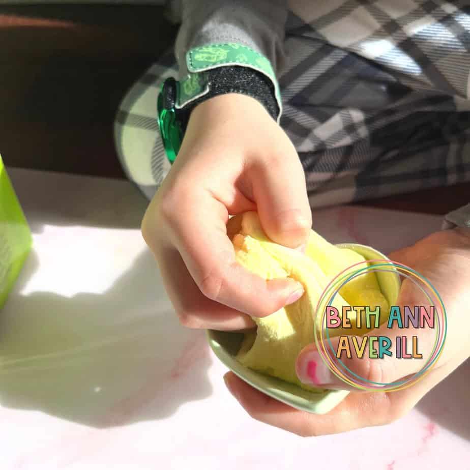 small hands kneeding peeps play dough
