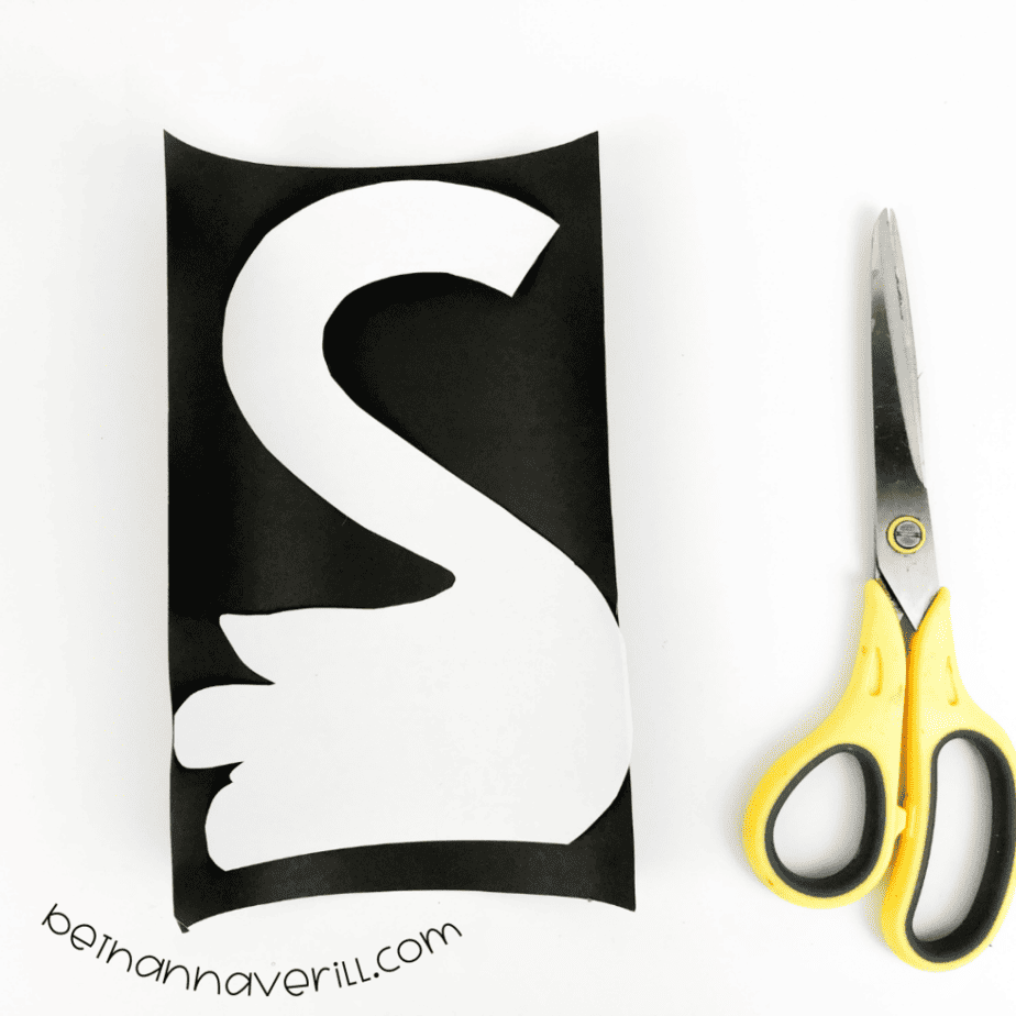 White S template glued onto black paper with a border