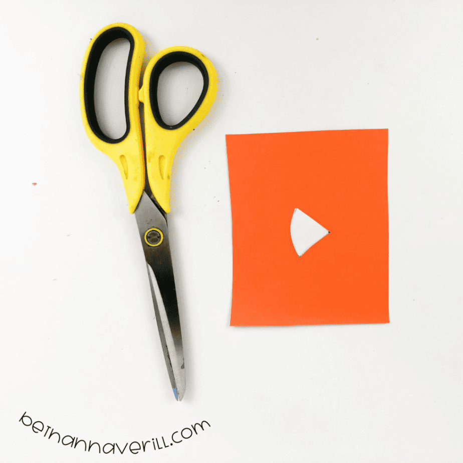 Orange paper with a wedge-shaped bill cut out