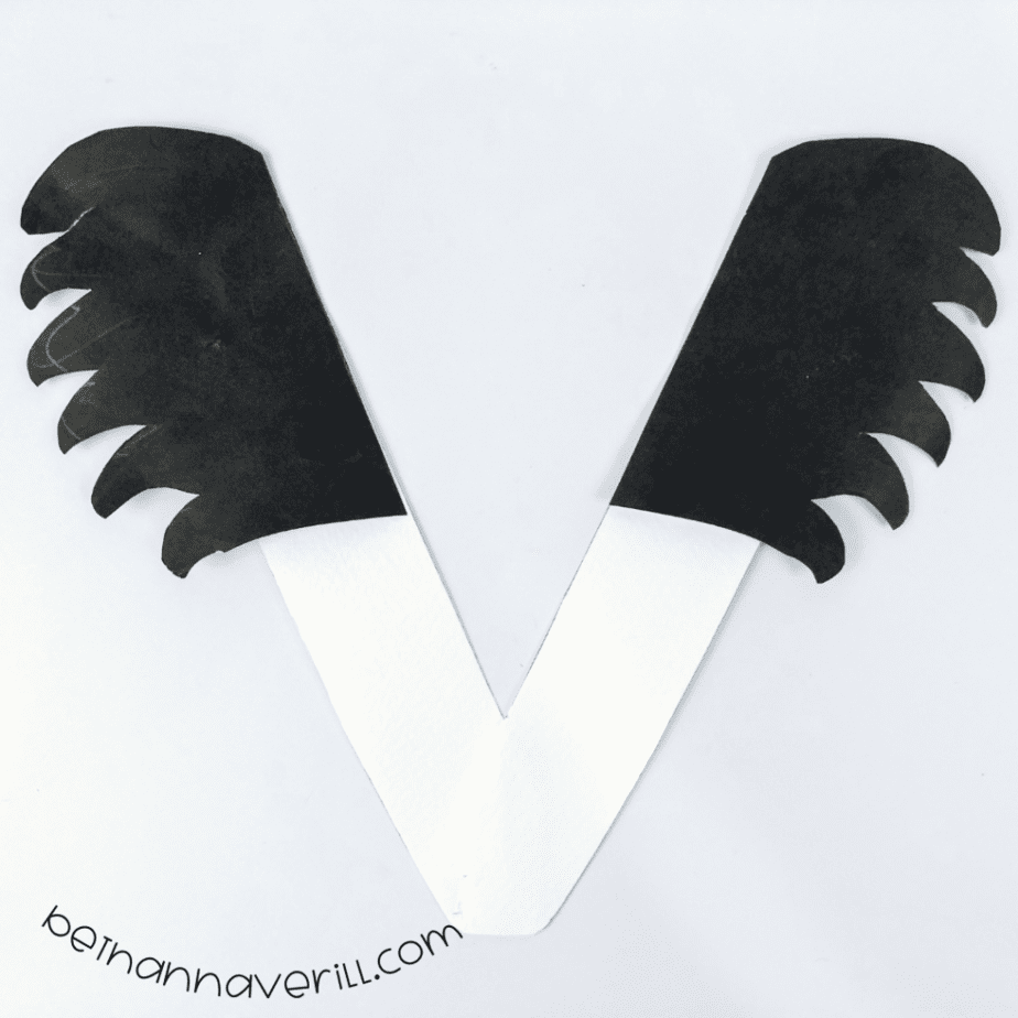 Black wings attached to the top of the V