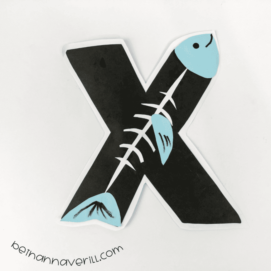 X-ray fish X mounted on white with a drawn eye and mouth