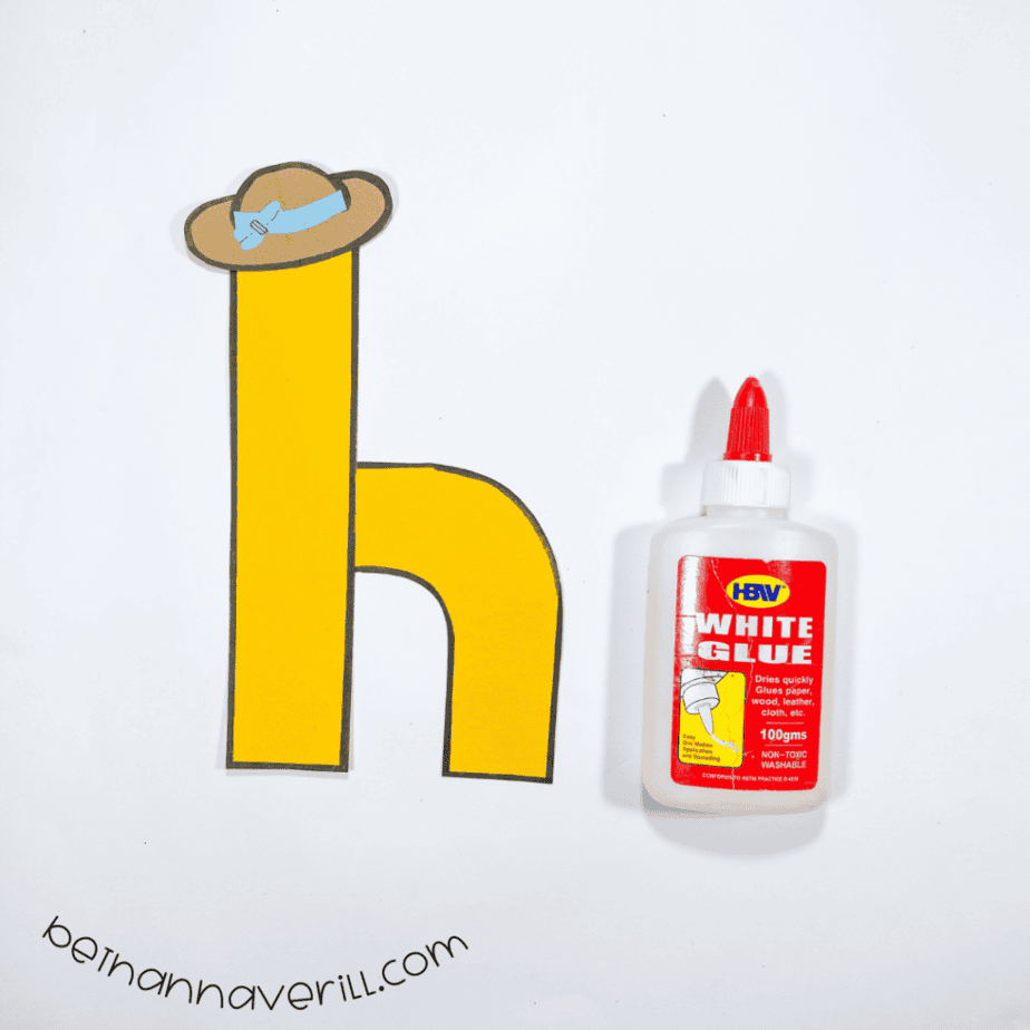 Blue bow on the hat, glued on top of the lowercase h