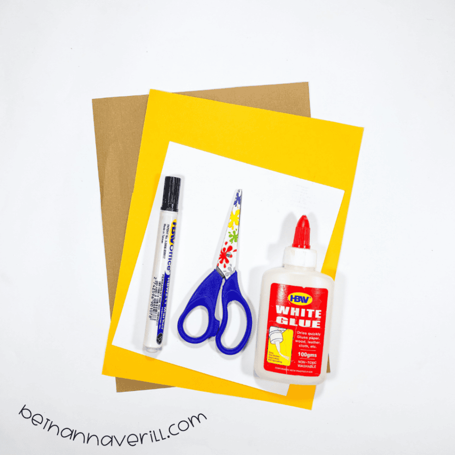 Construction paper, glue, a marker, scissors and the printable j is for Jaguar template