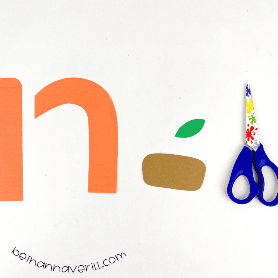 The n is for Nest shapes cut from orange, brown, green and white construction paper
