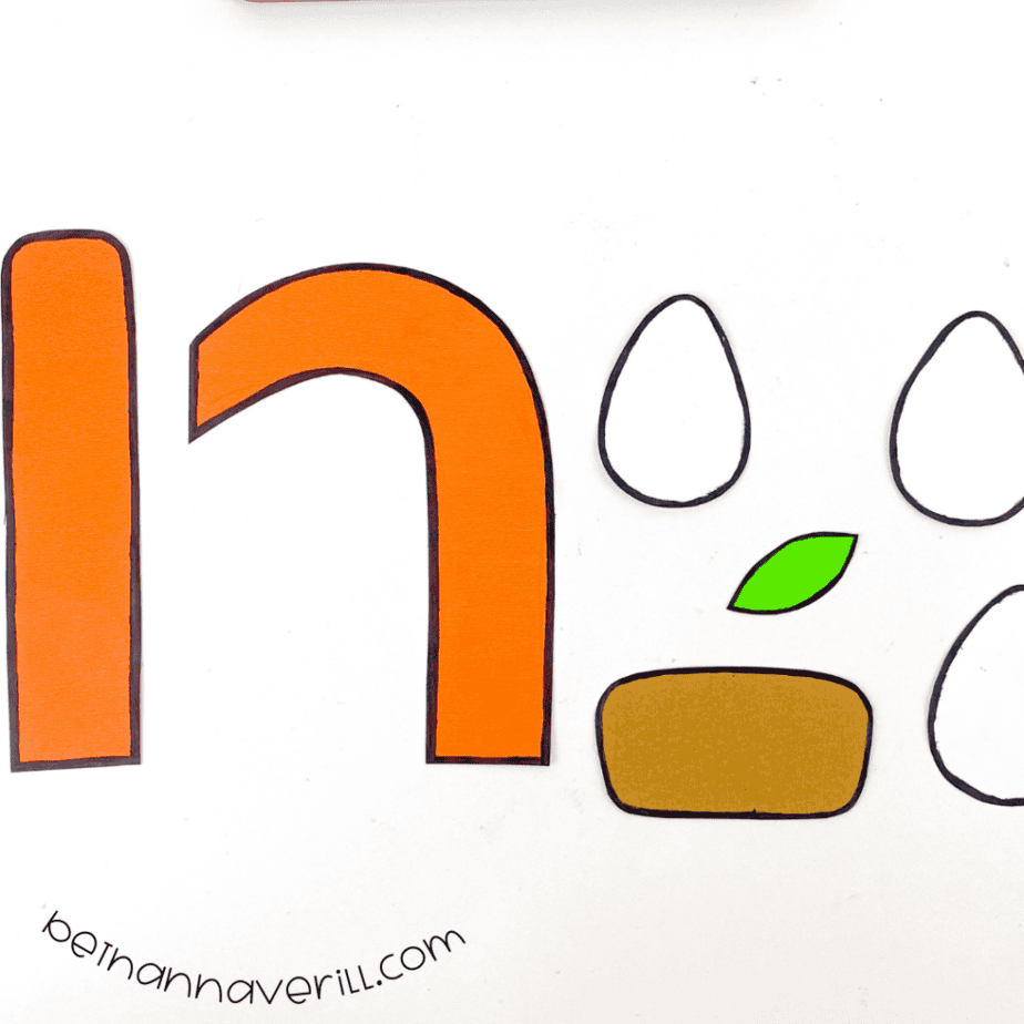 Black marker outlines around the n is for Nest paper shapes