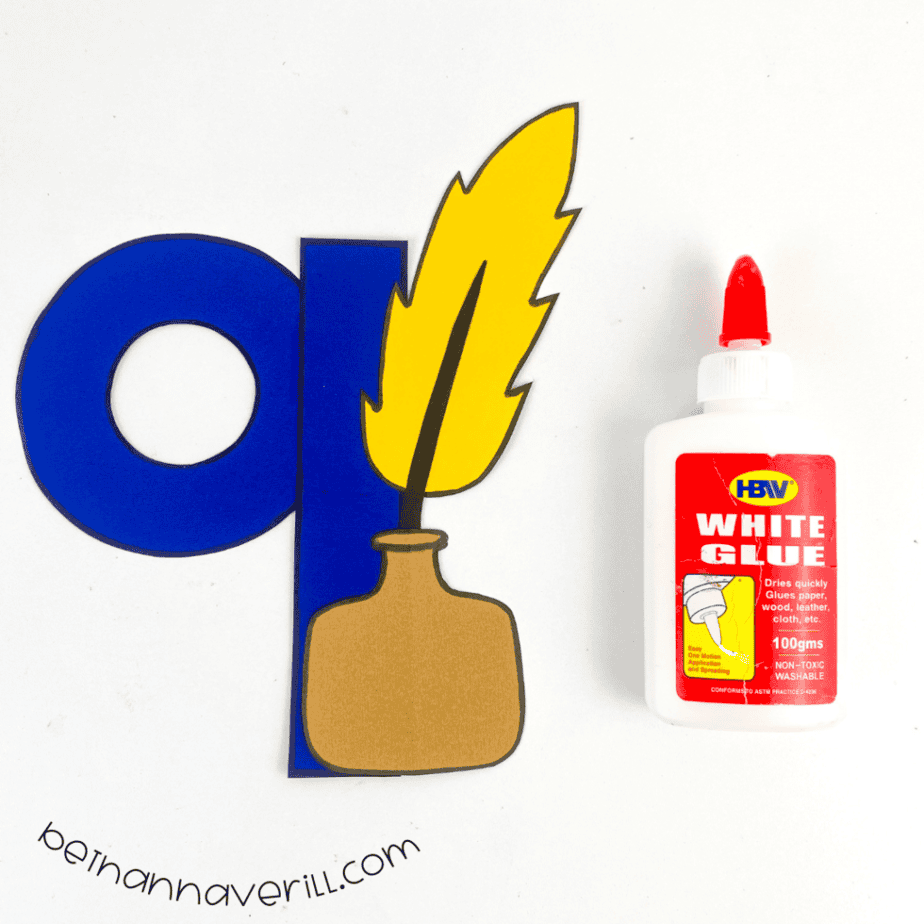 Quill and ink glued onto the blue lowercase q