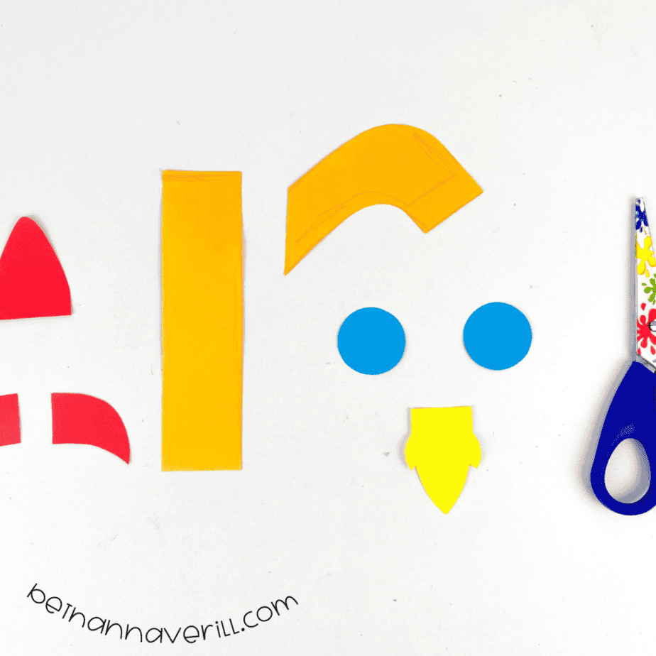 Red, orange, yellow and blue rocket pieces cut from paper