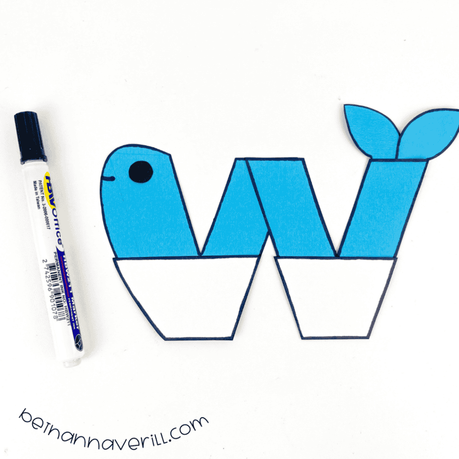 Blue pieces joined into a lowercase w whale with a black eye
