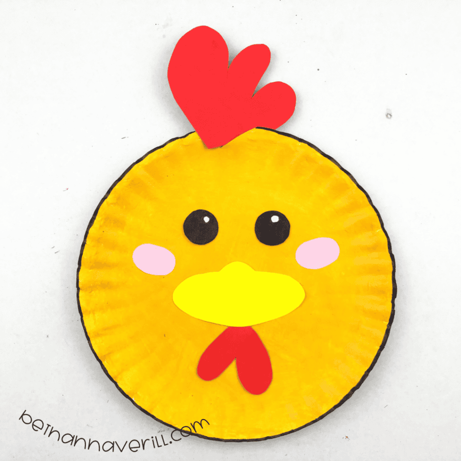 Finished yellow paper plate chicken craft with a red comb