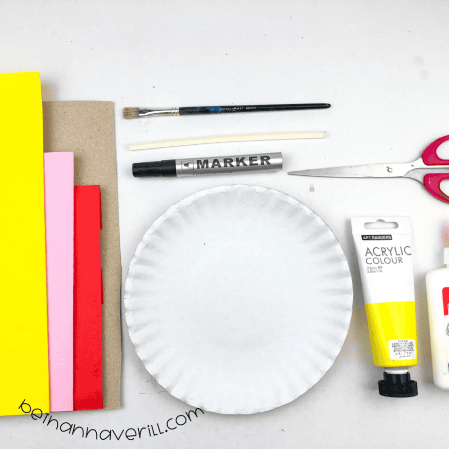 Yellow, pink and red construction paper, cardboard, glue, a paper plate, yellow paint and scissors