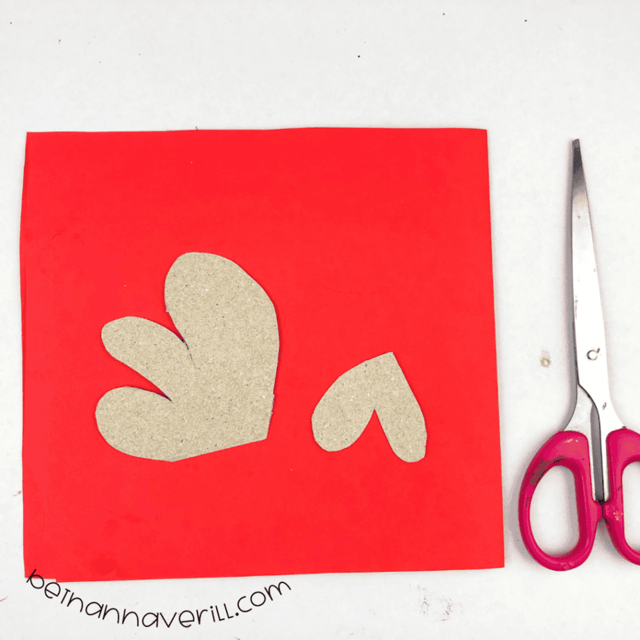 Cardboard comb and wattle pieces laid on red paper