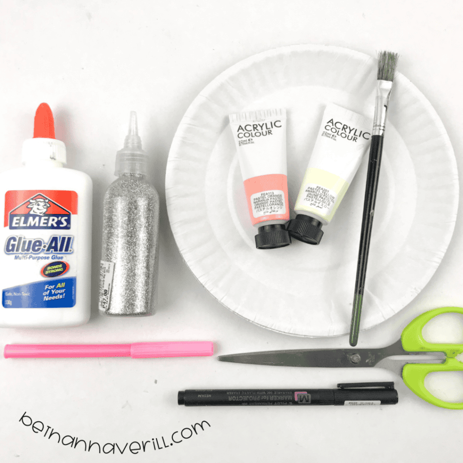 Paper plate, pink and yellow paint, glue, glitter, a pink pen, a marker and scissors