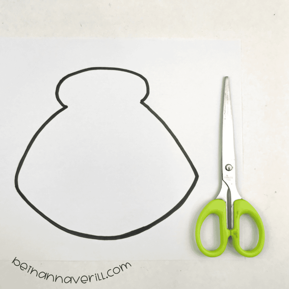 Clam shell template cut out next to scissors