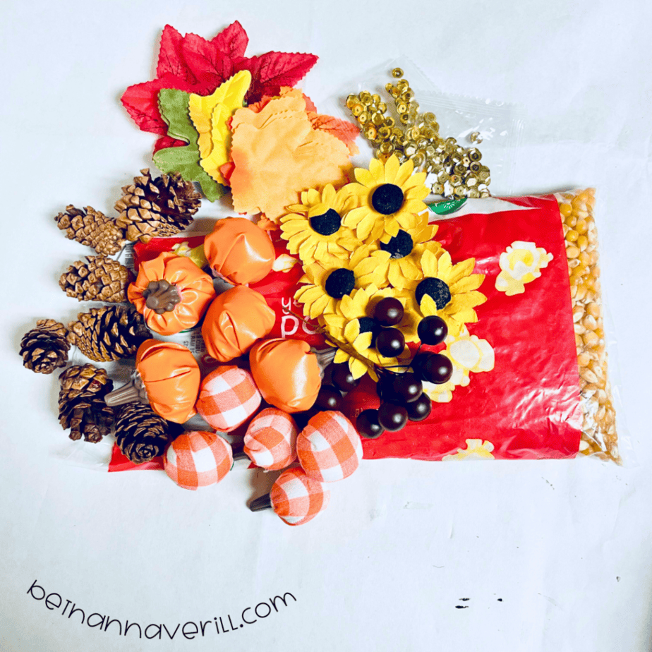 Fall leaves, pumpkins, sunflowers, pinecones and berries