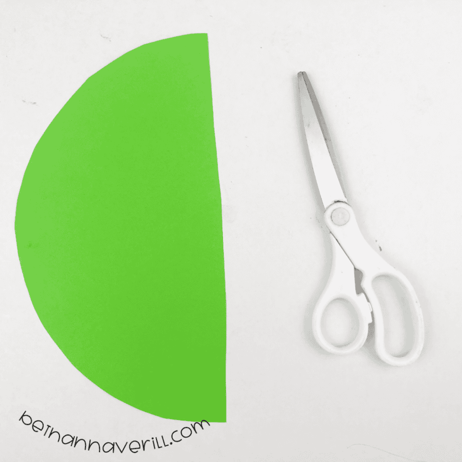 Green paper half circle cut to match the plate