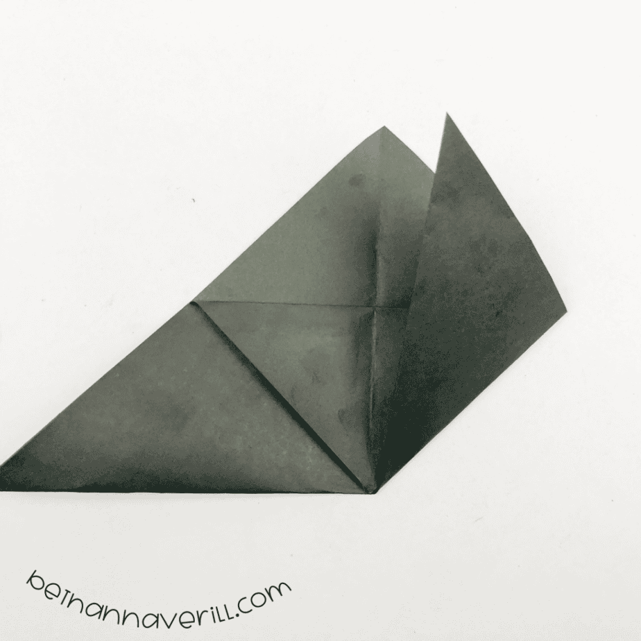 Black origami triangle with one side flap folded up