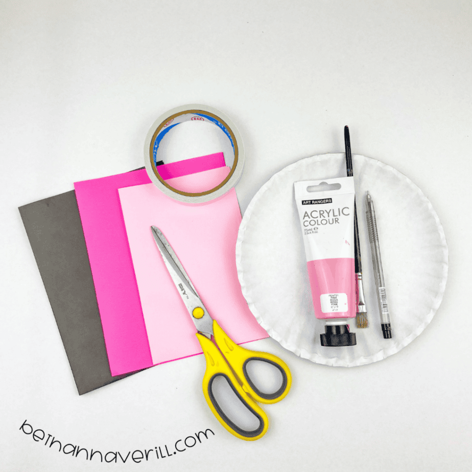 Paper plate, pink paint, black and pink construction paper, double-sided tape, a marker and scissors