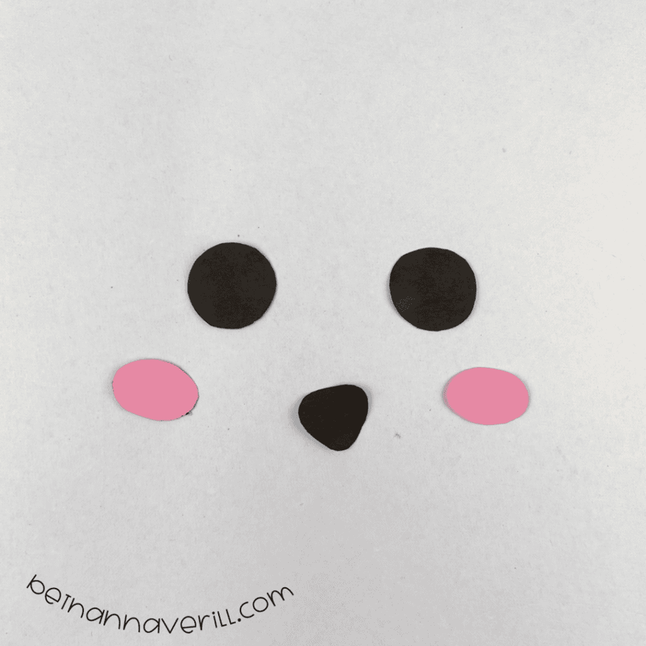 Black paper eyes and nose with pink cheeks