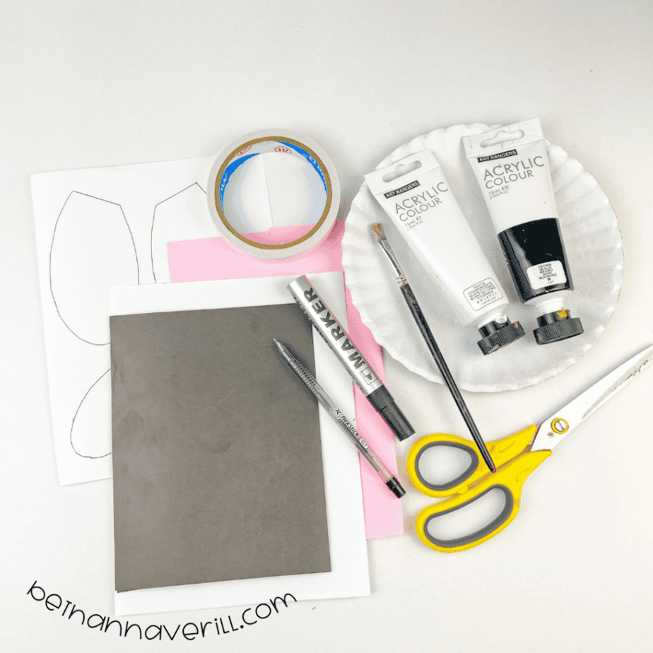 Paper plate, black and white paint, black and pink paper, cardboard, double-sided tape, a pen and scissors