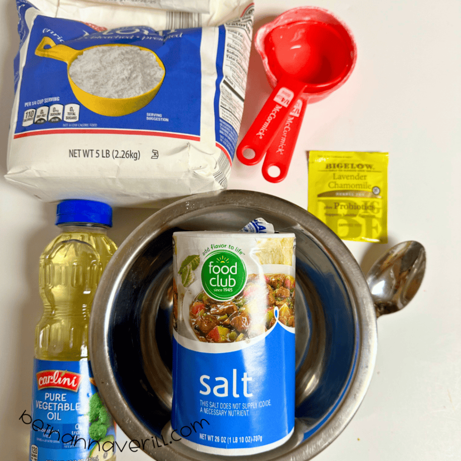 Chamomile tea playdough supplies including flour, salt, vegetable oil, cream of tartar, chamomile tea, and measuring cups