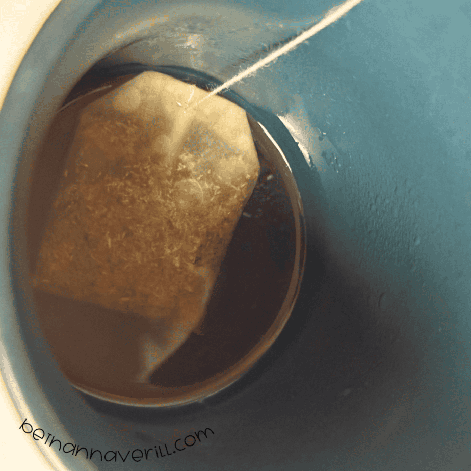 Chamomile tea bag steeping in a mug of hot water