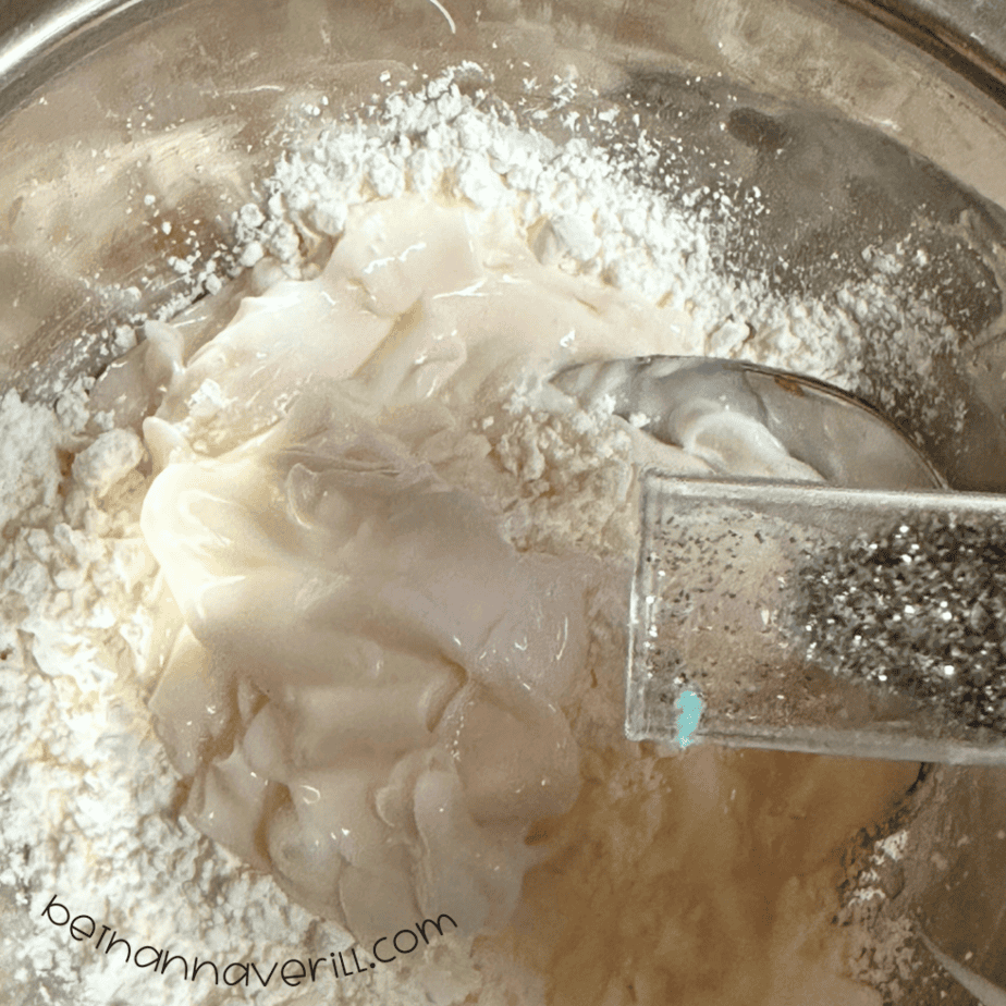 Silver glitter sprinkled over cornstarch and conditioner in a bowl