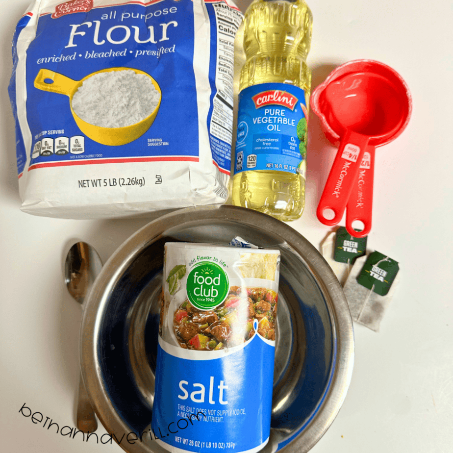 Green tea playdough supplies including flour, salt, vegetable oil, green tea bags, and measuring cups