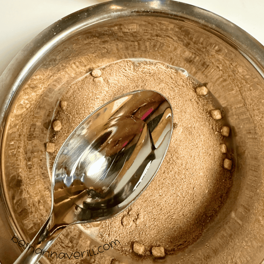 Spoonful of oil added to the brown hot cocoa playdough mixture