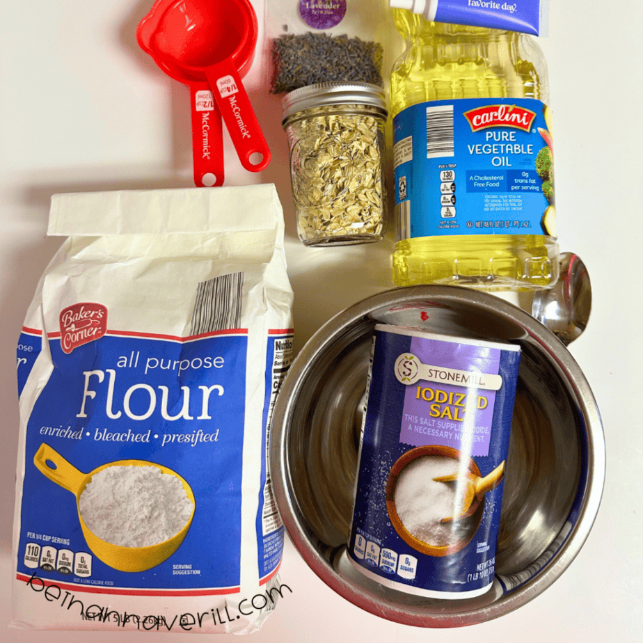 Lavender oatmeal playdough supplies including flour, salt, oats, dried lavender, vegetable oil, and measuring cups