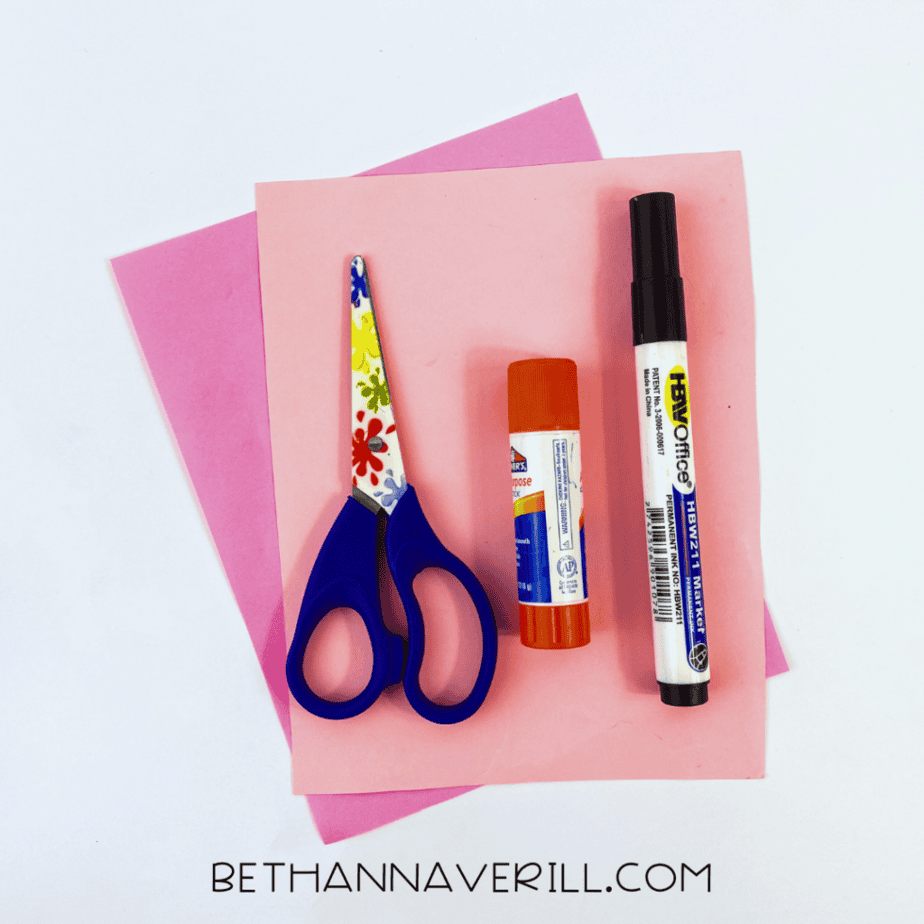 Valentine cat supplies: pink paper, glue stick, marker and scissors