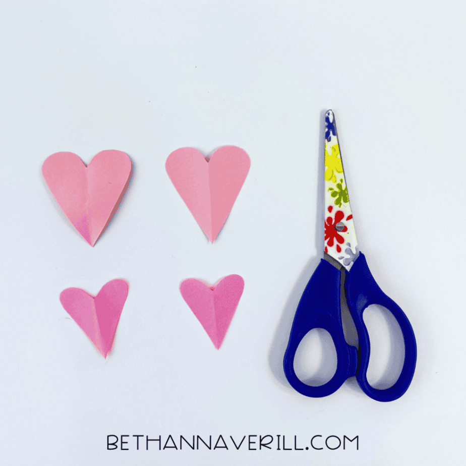 Light and dark pink paper hearts cut out