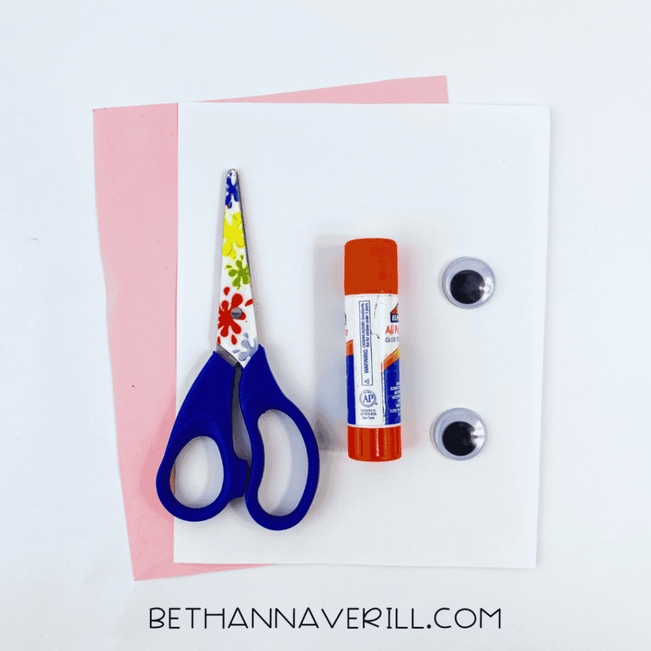 Valentine cow supplies: white and pink paper, googly eyes, glue stick and scissors