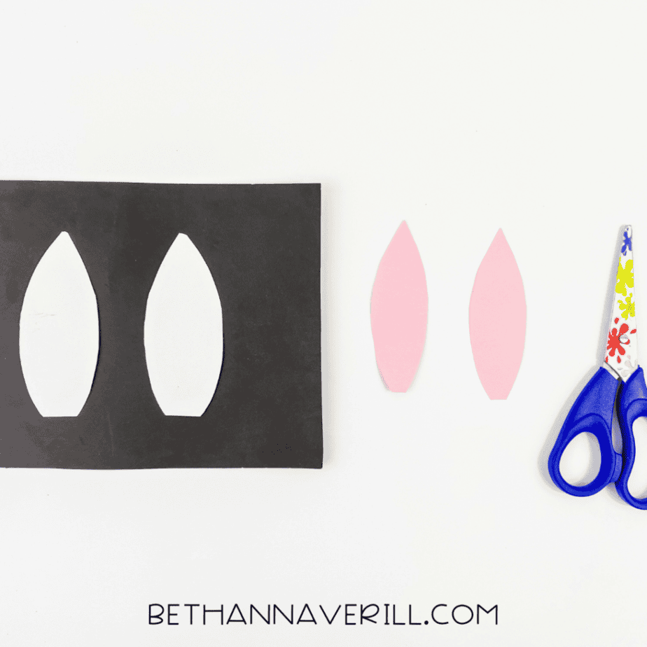 White and pink bunny ears cut from paper