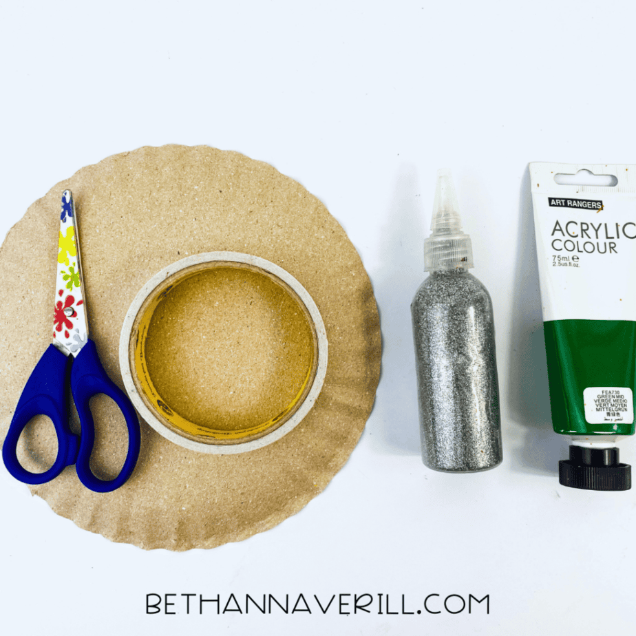 Shamrock wand supplies: paper plate, green and gold paint, glitter glue and scissors