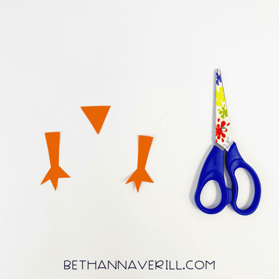 Orange paper chick legs and beak cut out