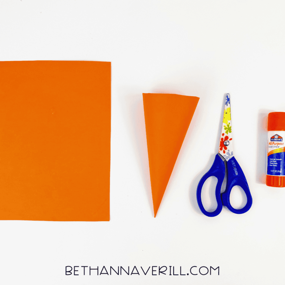 Orange paper rolled into a carrot cone