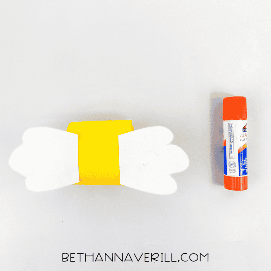 White wings glued to a yellow paper loop
