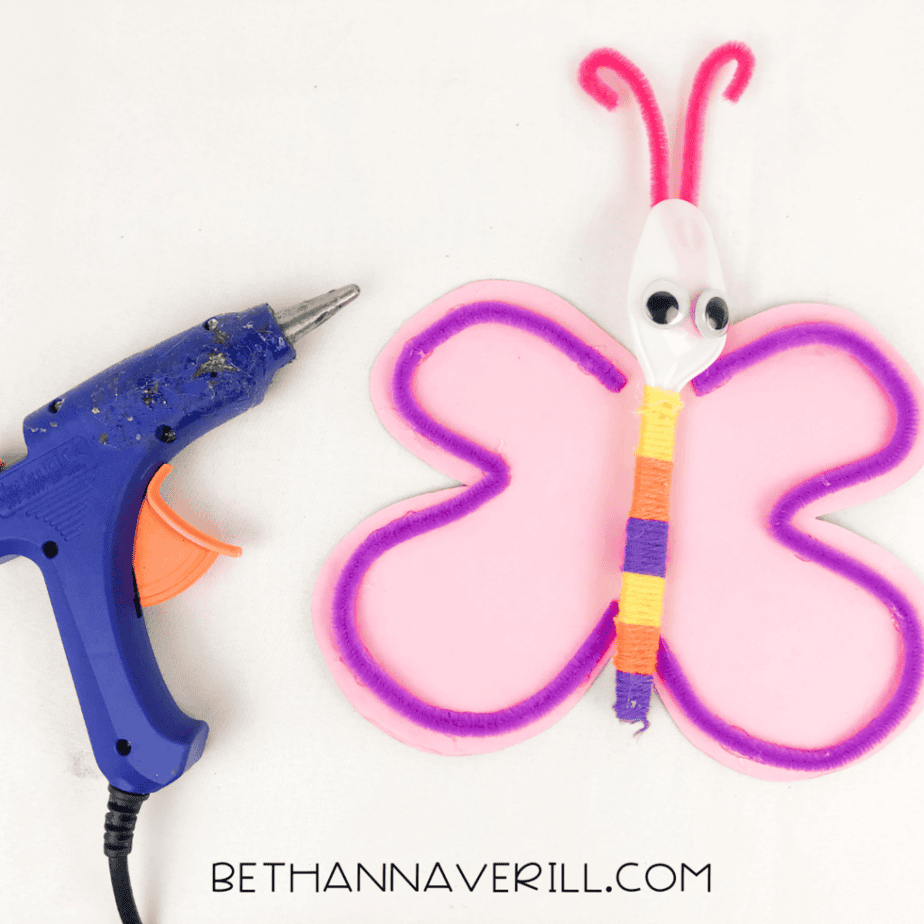 Yarn-wrapped spoon glued onto the pink foam wings