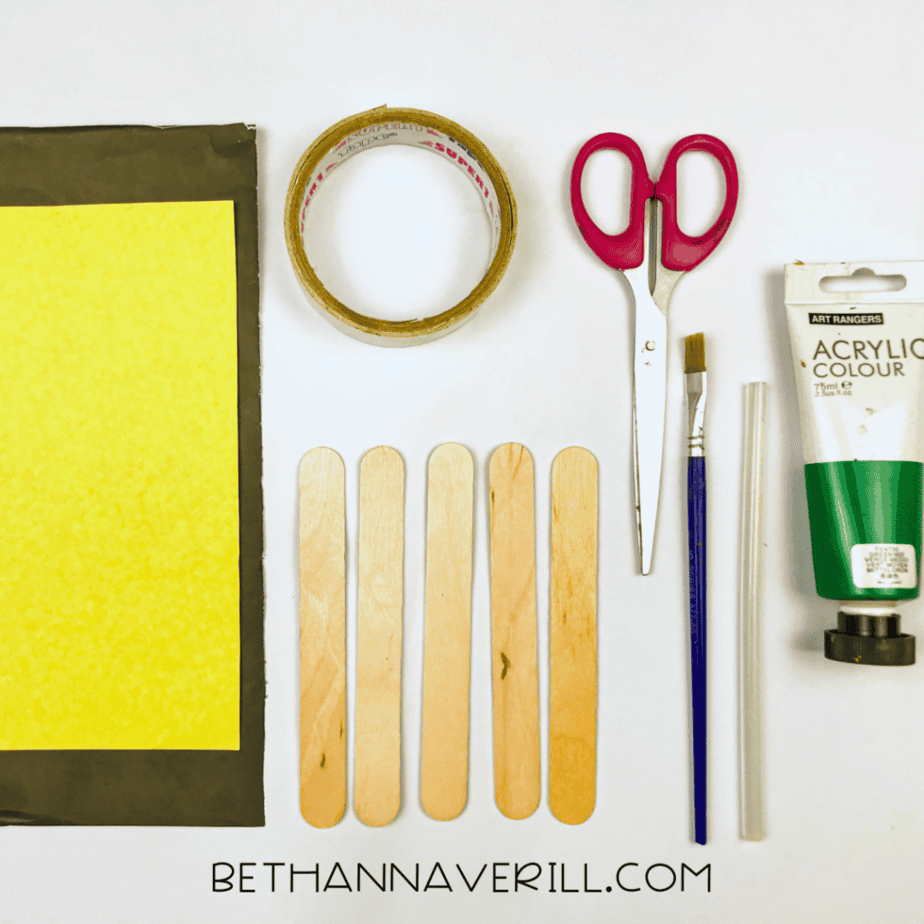 St. Patrick’s Day hat supplies: craft sticks, green paint, black and yellow paper, tape and scissors