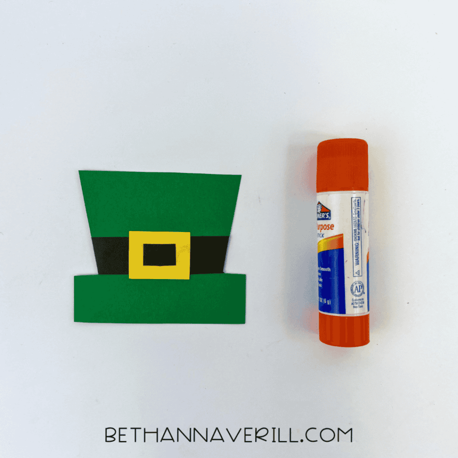 Assembled green leprechaun hat with black band and yellow buckle