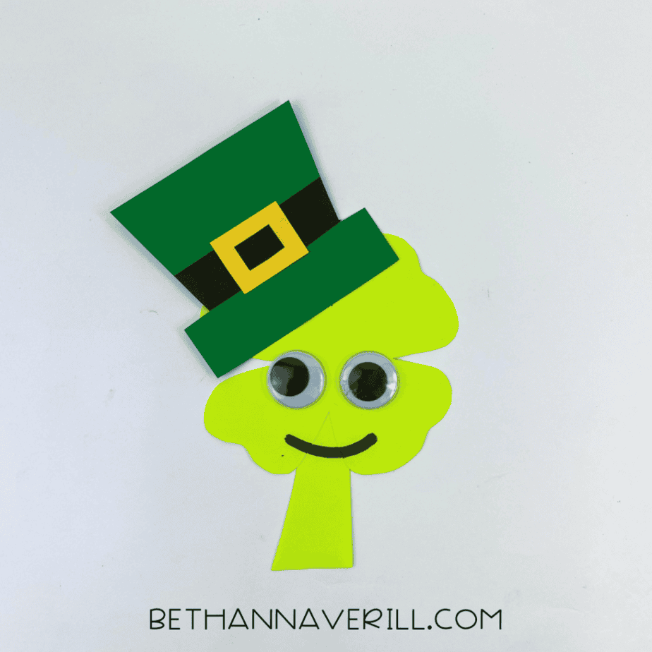 Finished shamrock man paper craft with leprechaun hat, googly eyes and smile