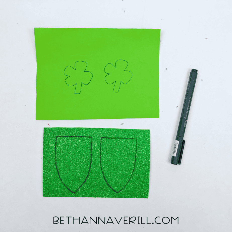 Banner shapes and shamrocks traced on green paper