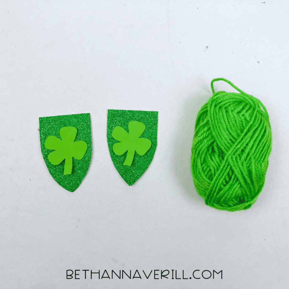 Shamrock banners next to a ball of green yarn