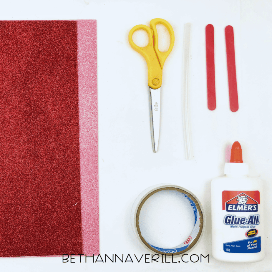 Heart key supplies: sparkly red and pink paper, red craft sticks, glue, tape and scissors
