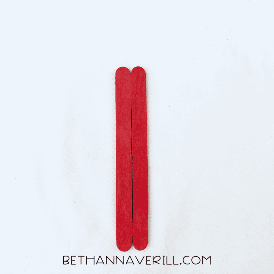 Two red craft sticks glued together