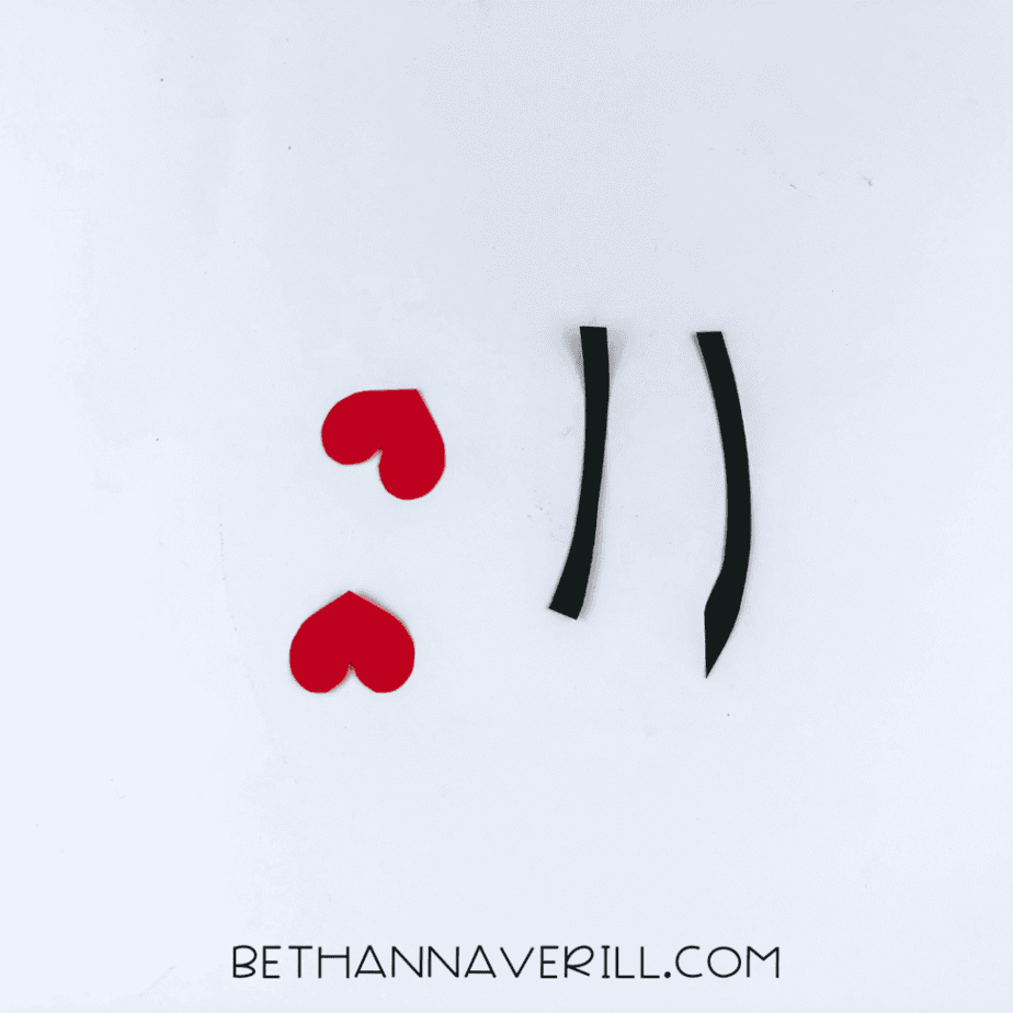 Black antennae and red heart tips cut out